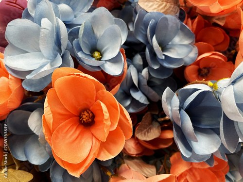 Bild auf Leinwand Colorful artificial flower background with blue and coral fabric blossoms creati