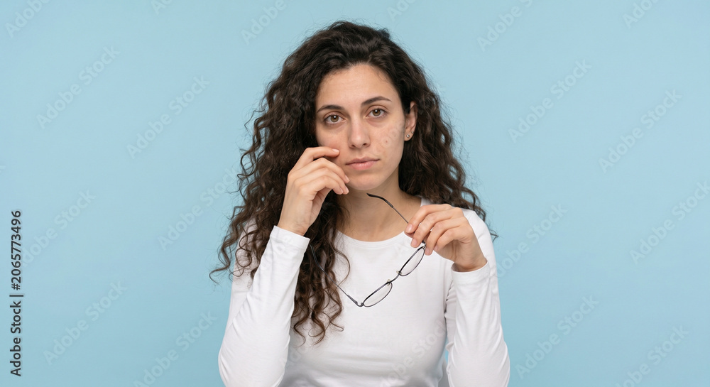 Fototapeta premium Portrait of an exhausted young woman, showing symptoms of stress, depressed mood or chronic fatigue