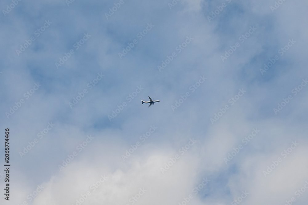 Fototapeta premium Airplane flying high in sky, commercial passenger aircraft airliner in clouds, aviation trip and travel concept