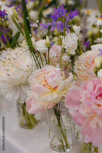 Soft floral arrangements with pink peonies and wildflowers.