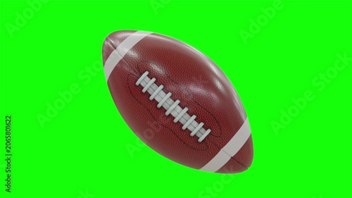 American football ball rotating seamlessly in a full loop isolated on green screen chroma key background