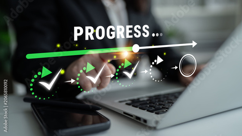 фотографія Business professional working on laptop showing progress with check marks on a digital interface in a modern office setting