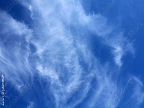 Clear blue sky with fine, white cirrus clouds. Sky background.