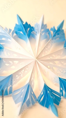 Blue feather with sunlit rays and sky background.