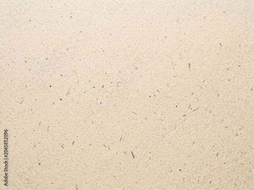 Beige paper texture background. Smooth surface of recycled cardboard with natural flecks. Vintage craft material for letter writing, document backdrop and creative graphic design