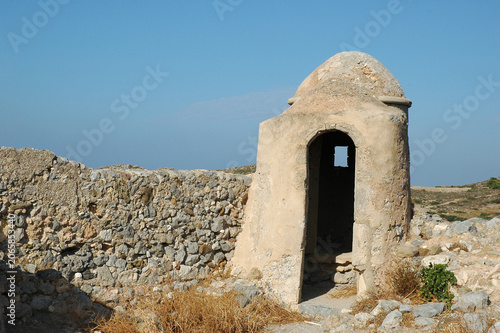 Historic stone watchtower guardhouse on the Venetian castle wall of Chora in Kythira island Greece under clear blue sky