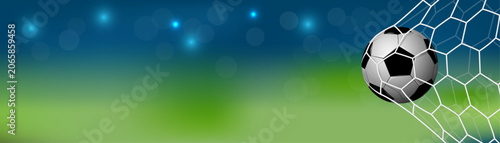 Fotografía Soccer ball hitting net in football stadium goal with bokeh background