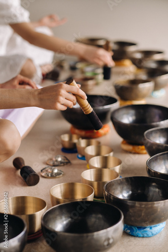 Εκτύπωση καμβά Close-up of a Tibetan singing bowl in your hands - Translation of mantras: trans