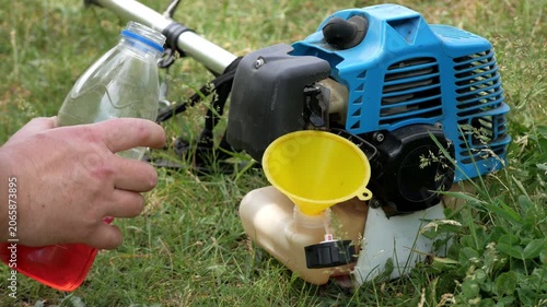 Pouring Fuel and Oil Mixture into Brush Cutter Tank Outdoors