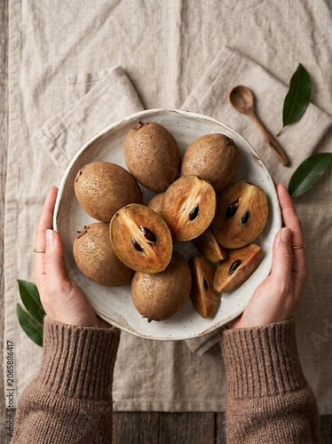 Hands Holding Fresh Sapodilla