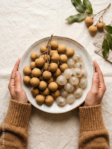 Hands Presenting Fresh Longan Fruit