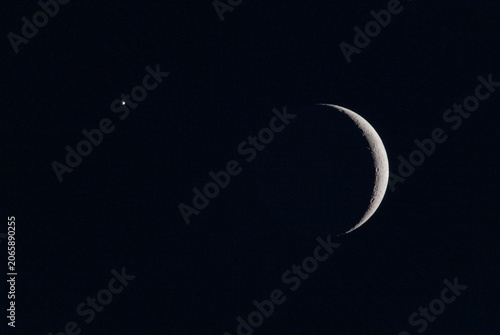 Planetary conjunction of Venus and crescent moon phase in a clear dark sky