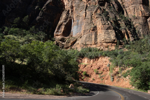 Konstfotografi Evening light on Utah SR 9 as it passes rocky bluffs and Utah juniper trees in Z