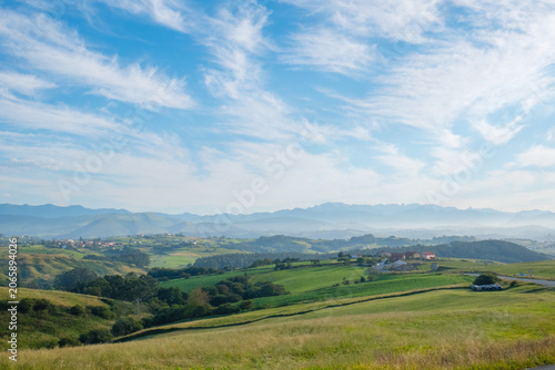 Panoramic countryside landscape with green hills and dramatic sky