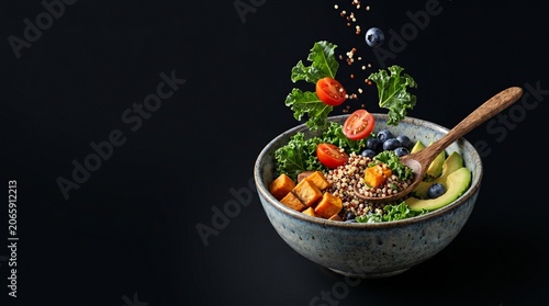 Healthy Quinoa Bowl with Kale Avocado Tomatoes Blueberries and Sweet Potato Ingredients Levitating