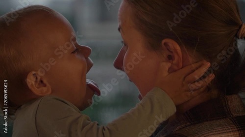 Caucasian mother and daughter embracing closely touching foreheads , expressing comfort, trust, emotional support. Useful parenting, family care, bonding, mental wellbeing themes, child having fun