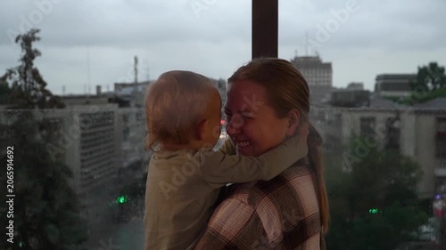 Caucasian mother daughter embracing closely touching foreheads , expressing comfort, trust, emotional support. Useful parenting, family care, bonding, mental wellbeing themes, child having fun arms