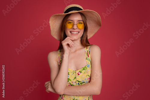 Smiling woman in straw hat and sunglasses