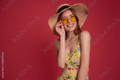 Smiling woman in straw hat and sunglasses