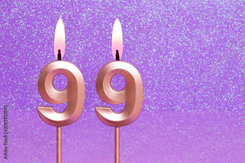 Number 99 on a pink background with blurred bright dots - Birthday or anniversary card with abstract blurred dots that glow
