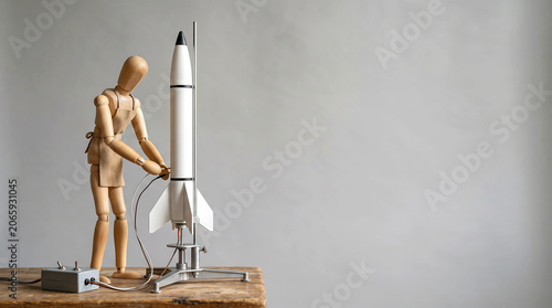 Mid-year performance reviews and KPI tracking concept with wooden mannequin setting up rocket launcher with copy space for business growth analysis presentation banner