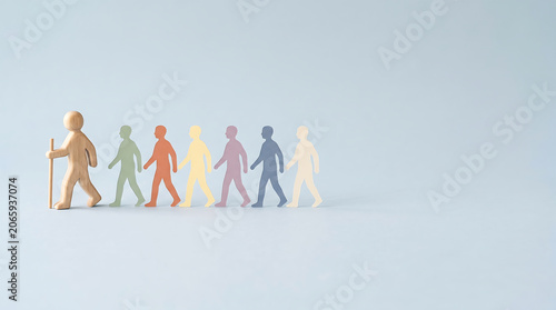 Team leadership employee evaluation and diversity kpi tracking management concept with wooden figure leading colorful paper crowd with copy space for mid year performance review presentation banner
