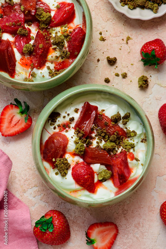 Greek yogurt with roasted rhubarb and strawberries and matcha oat crumble. .