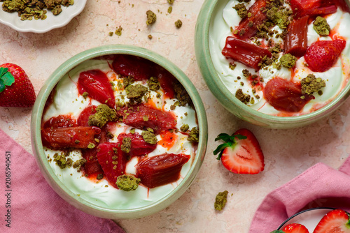 Greek yogurt with roasted rhubarb and strawberries and matcha oat crumble. .