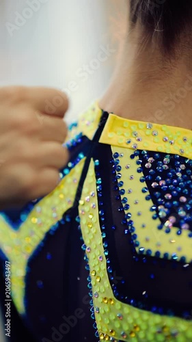 Costume preparation for performance at the dance studio with focus on the zipper and sequins