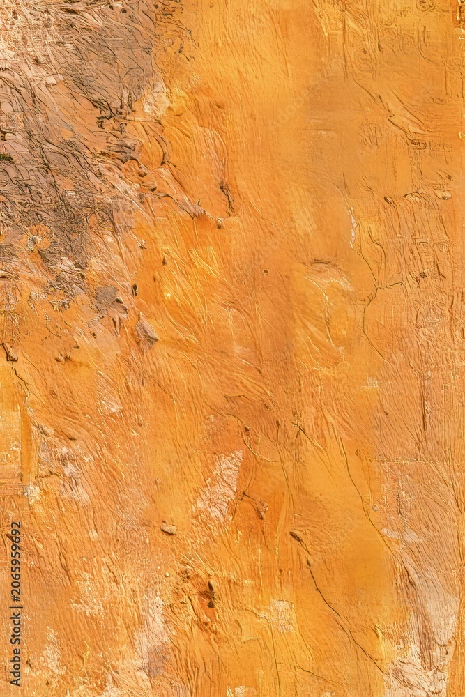 Naklejka premium Surface showing a range of orange and brown shades with texture and patterns present in natural rock formation found outdoors