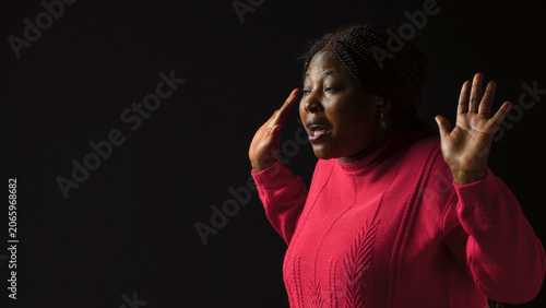 Canvas Print Young lady making I dont know gesture, lifting her shoulders implying confusion and uncertainty, with being ignorant and insecure with perplexed and bewildered reaction in isolated Black background