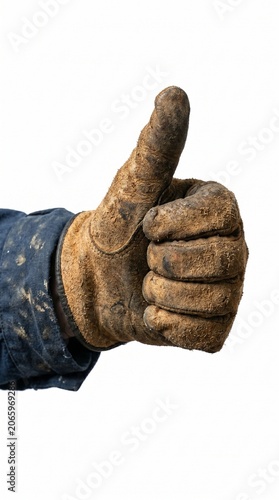 Hand wearing dirty leather work glove giving a thumbs up gesture isolated on white background.