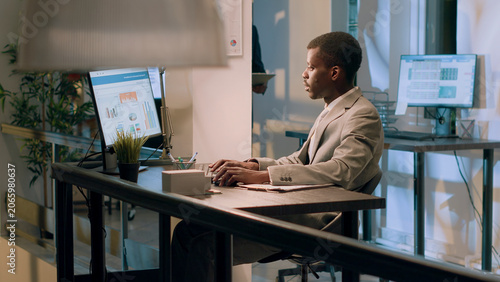 Fotografía Meticulous bookkeepers verifying documents information on computer for accuracy and completeness during night shift, employees working overnight in office, checking company figures