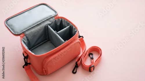 Open Orange Camera Bag With Adjustable Compartments.