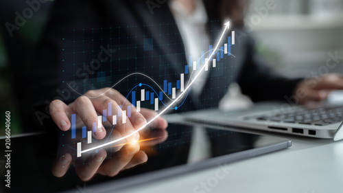 Принти на полотні A business professional analyzes financial growth data displayed on a tablet, showcasing graphs and charts that signify success and market trends in modern business