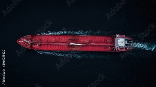 red cargo ship on dark ocean