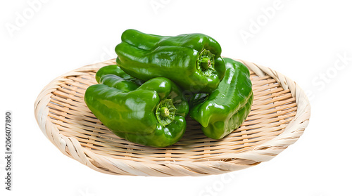 Fresh green bell peppers in a traditional woven bamboo basket with vegetable ingredient nutrition vegetarian culinary gastronomy wholesome capsicum preparation nutritionist freshness