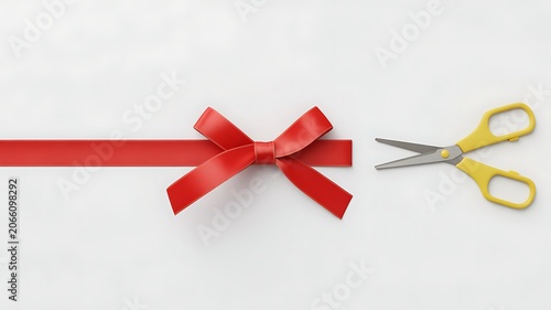 A minimalist photograph of a single red ribbon tied with scissors on a white surface