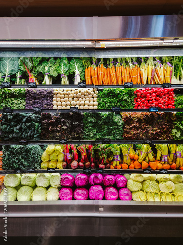 Fresh, colorful organic produce neatly displayed on shelves in a grocery store
