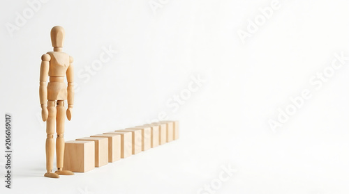 Employee evaluation performance management concept with wooden mannequin standing next to block bar graph with copy space for business growth presentation banner