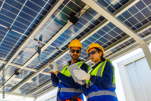 Solar Technicians Installing Microinverter Under Panels