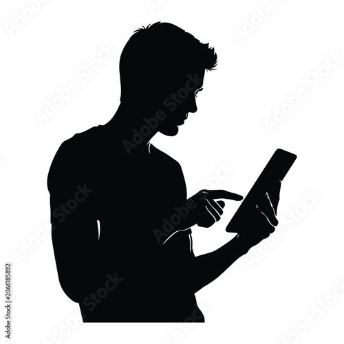Silhouette of a man browsing on a tablet, side view