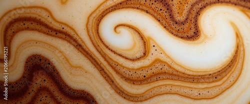Macro shot of coffee and milk swirl abstract pattern with tiny bubbles.