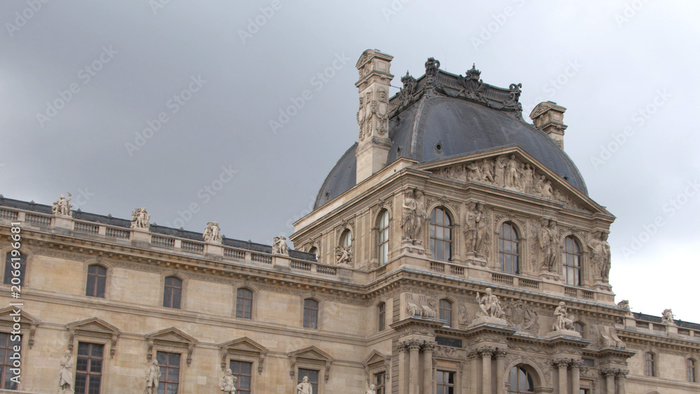 Fototapeta premium Ornate Stone Facade and Domed Pavilion of the Louvre Museum