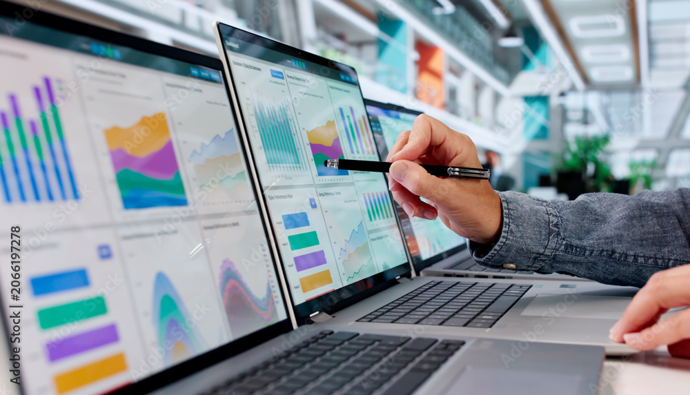 Fototapeta premium Experienced Financial Analyst Reviewing Multiple KPI Dashboards