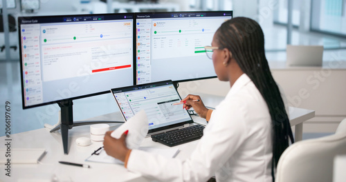 Young Woman Uses Laptop To Review Medical Billing