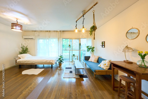 Bright studio apartment with bed sofa and dining table interior