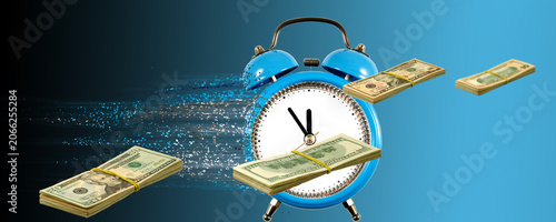 Fotografie A blue alarm clock shows the time while stacks of dollar bills seem to fly around
