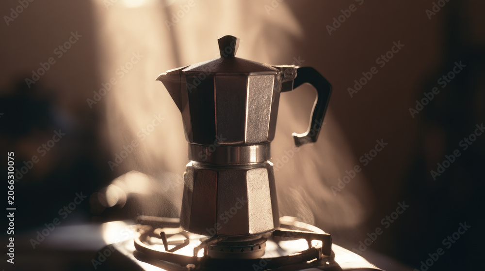 Fototapeta premium Small stove pot on gas burner in warm sunlight, solitary kitchen scene with soft haze and film grain