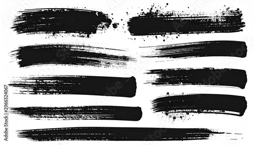 Variety of black brush strokes and splatters of various sizes arranged on white backdrop